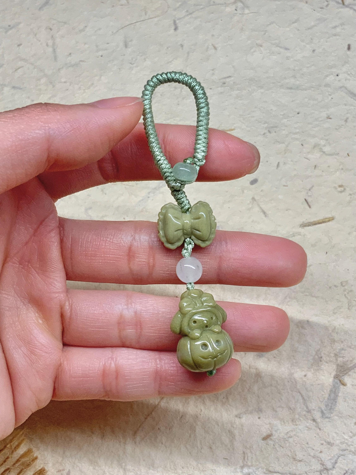 Green bunny bow Alashan agate bag charm close-up