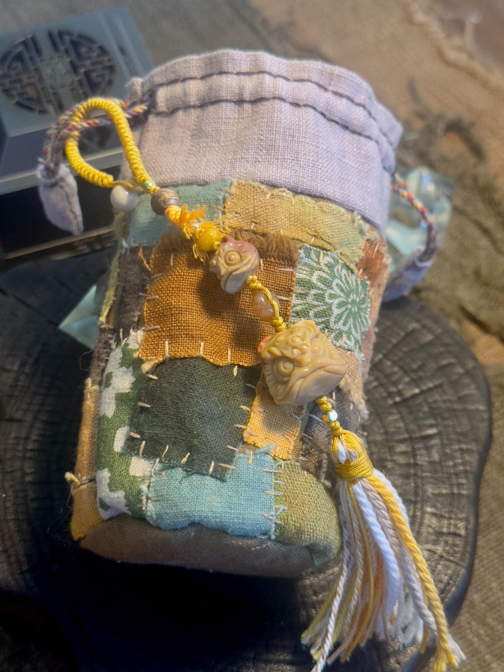 Carved lion dance natural stone handwoven charm close-up