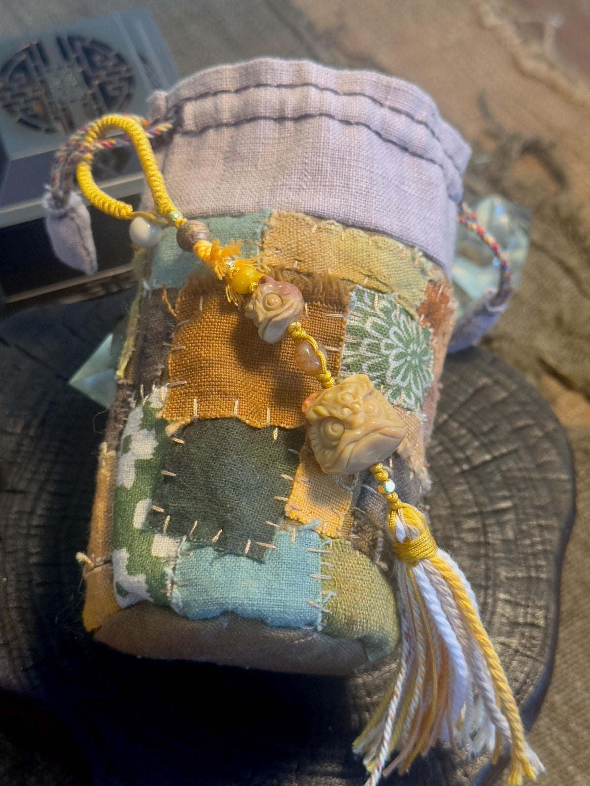 Carved lion dance natural stone handwoven charm close-up