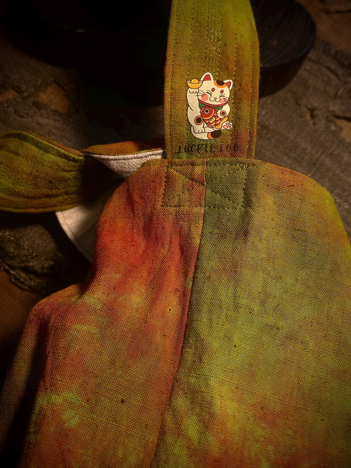 Natural plant dyed cotton shoulder bag in earthy orange olive and green tones