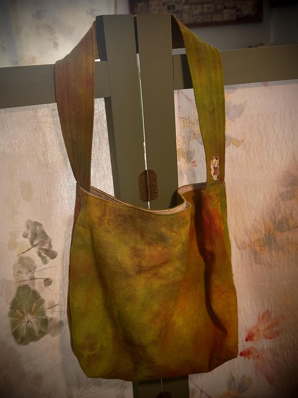 Natural plant dyed cotton shoulder bag in earthy orange olive and green tones