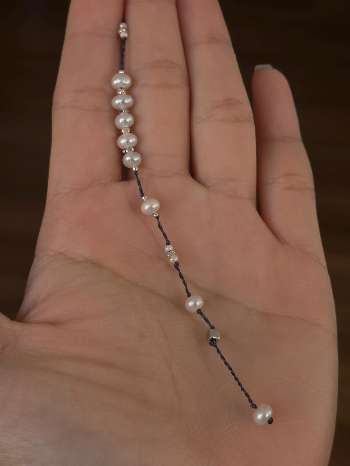 Freshwater pearl and sterling silver navy cord bracelet detail