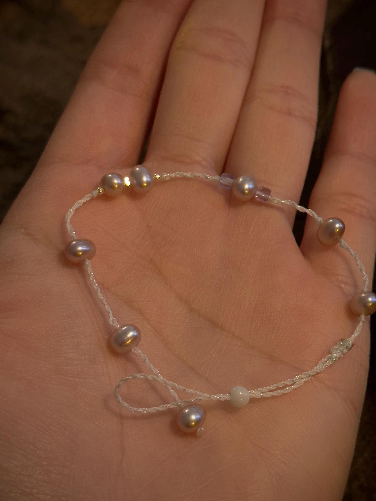 Handwoven freshwater purple pearl bracelet close-up