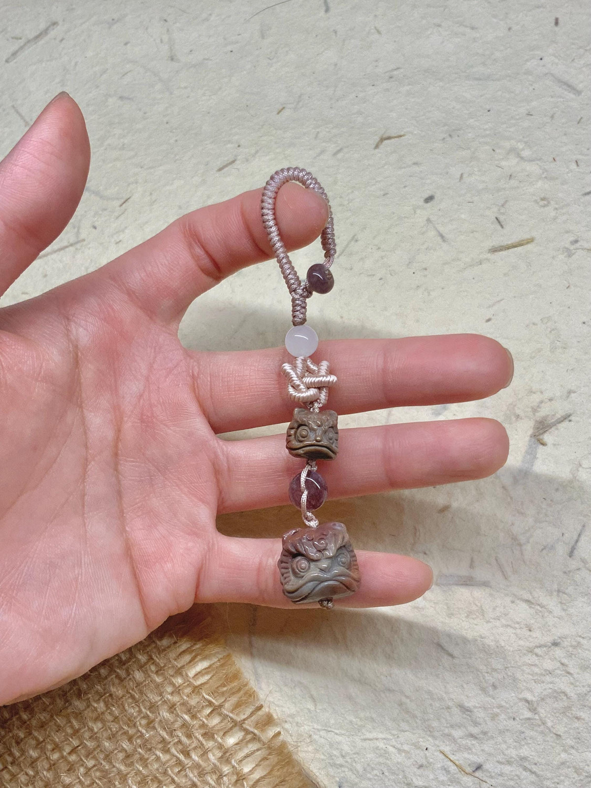 Purple red carved lion dance bag charm close-up