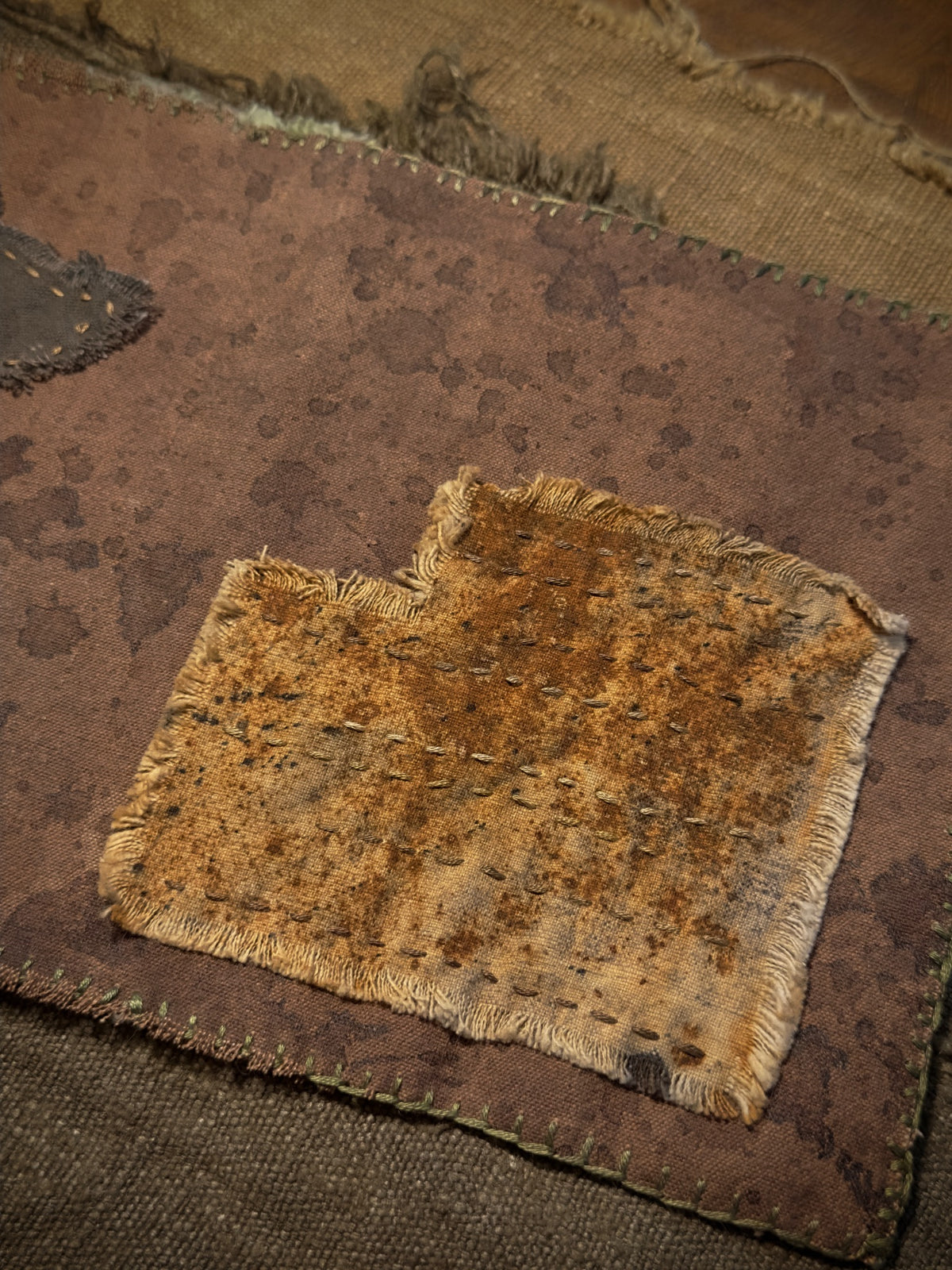 Close-up of hand stitching and naturally dyed textile texture