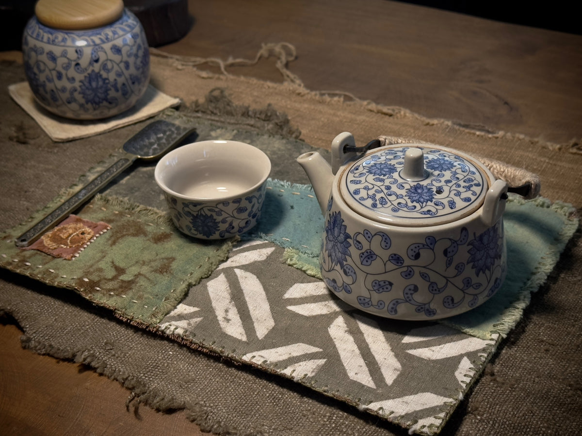 Plant-dyed patchwork tea mat styled with blue and white teaware
