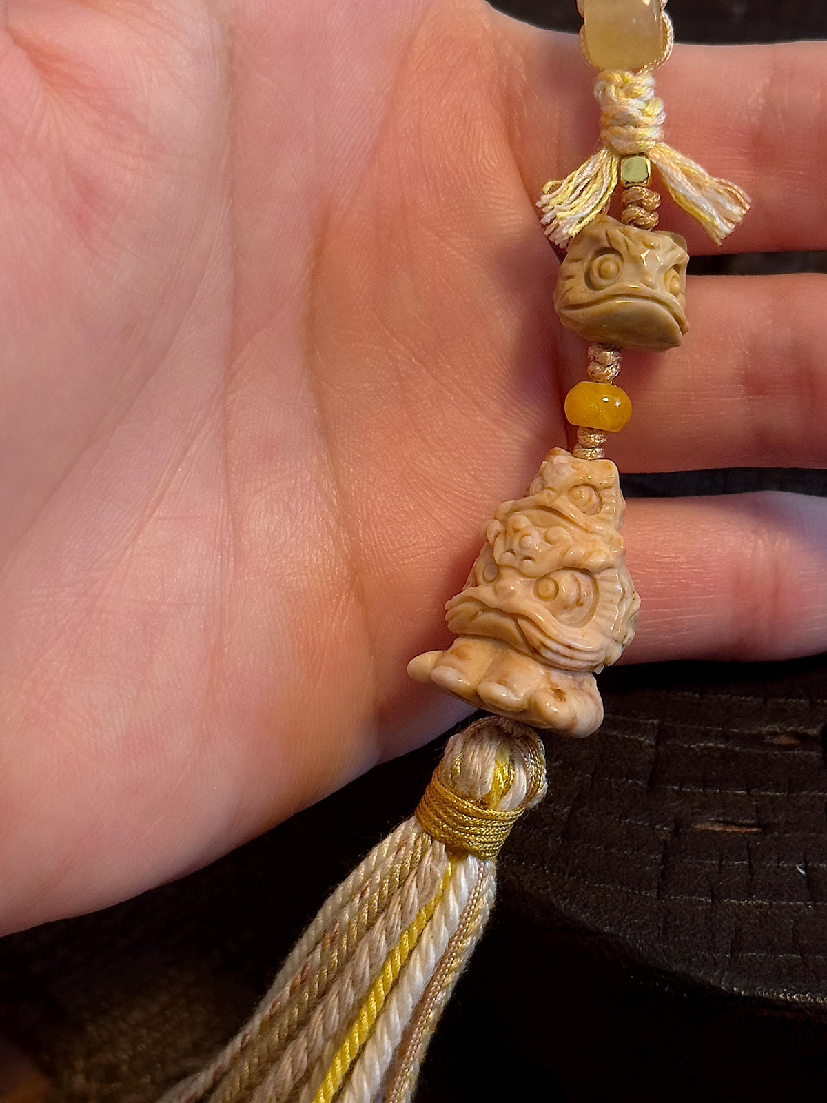 Handwoven lucky lion dance charm detail